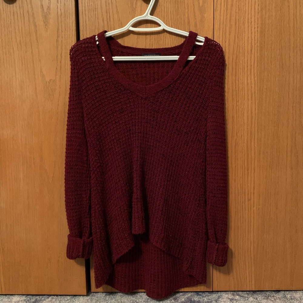 A burgundy V-neck sweater